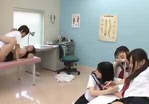 Doctor examining and mating back students in trainer